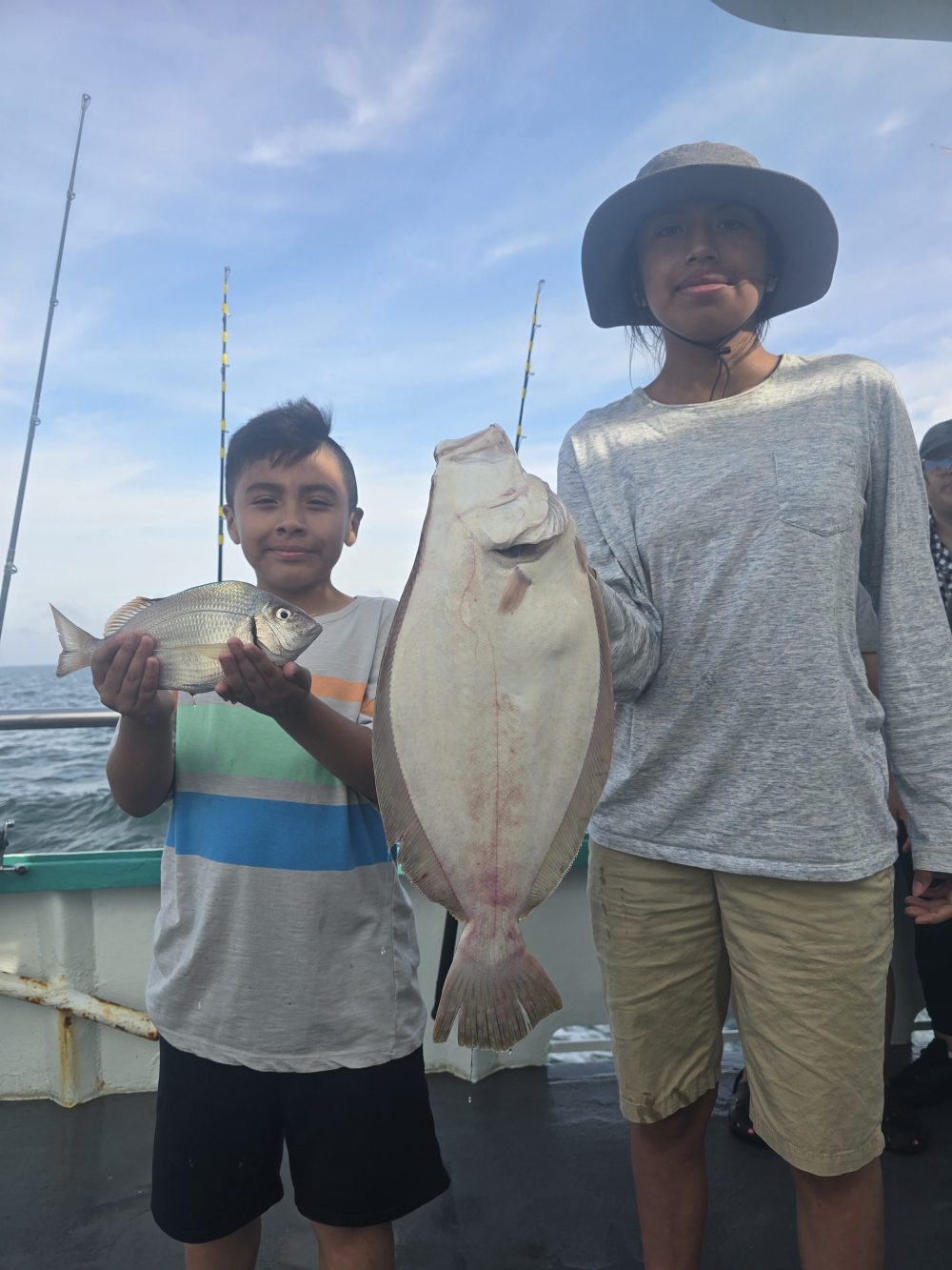 a young boy holding a fish