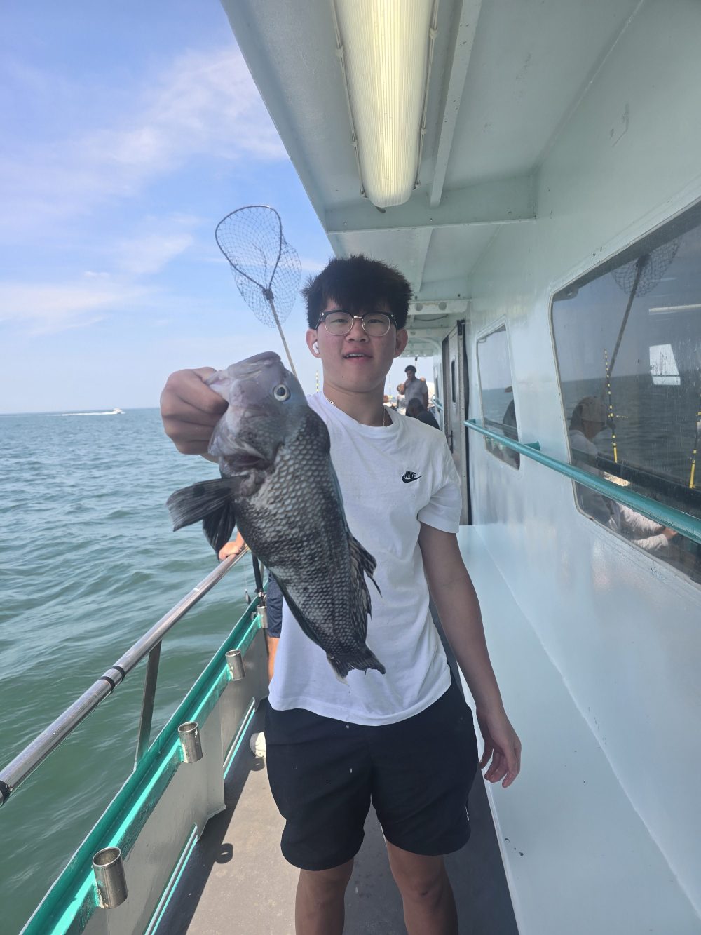a man holding a fish in the water