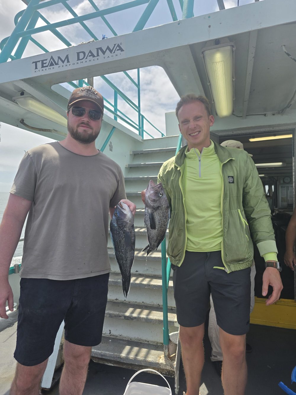 a person standing in front of a group of people posing for the camera