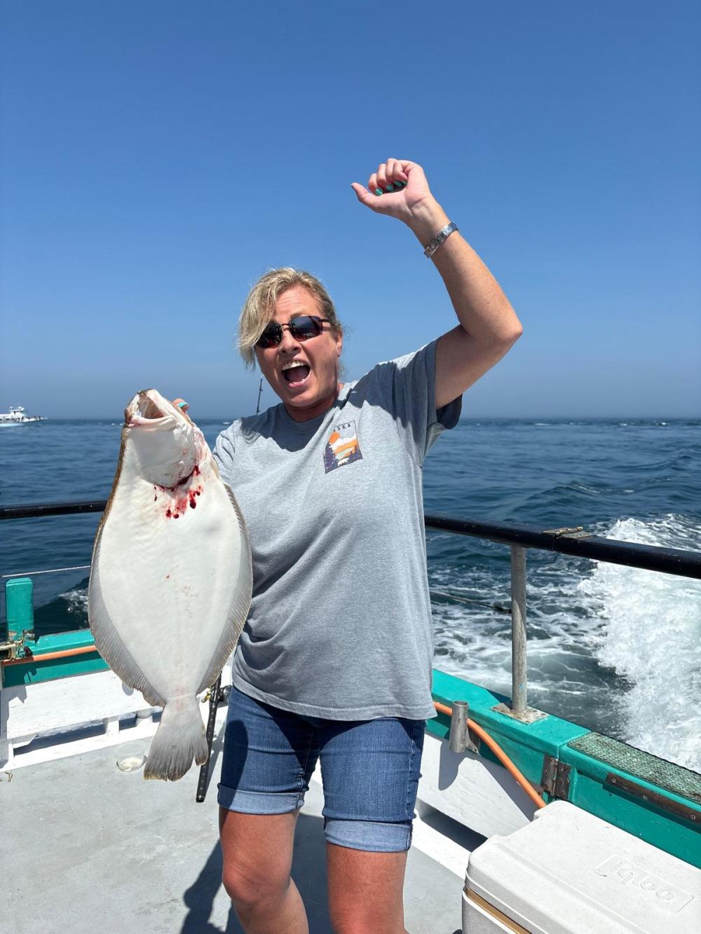 a person holding a fish in the water