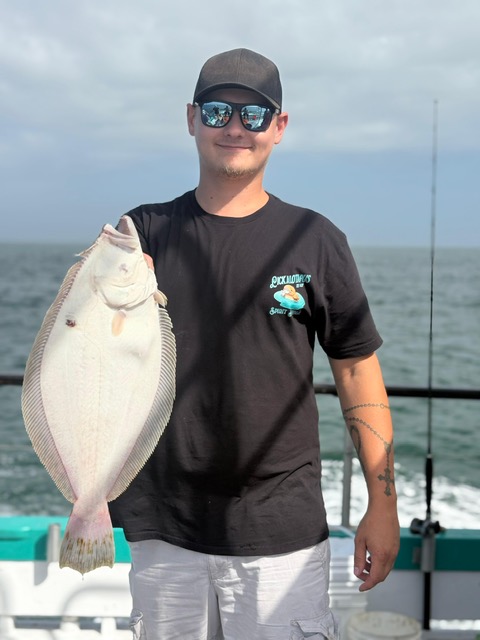 a man holding a fish in the water