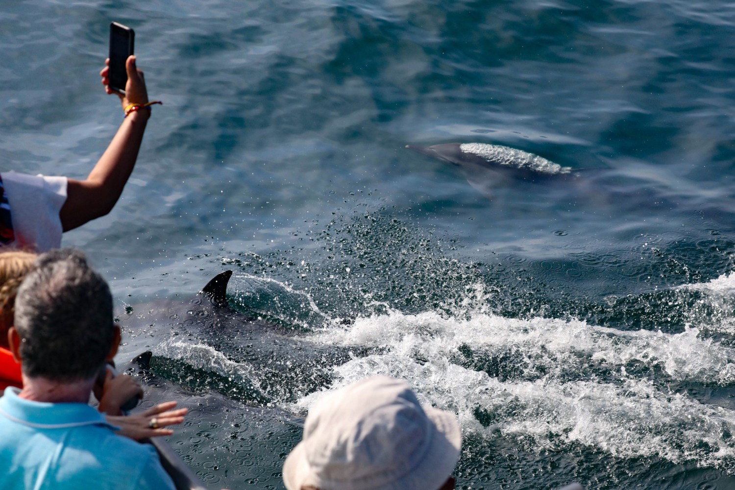 a young boy riding a wave on a surfboard in the water
