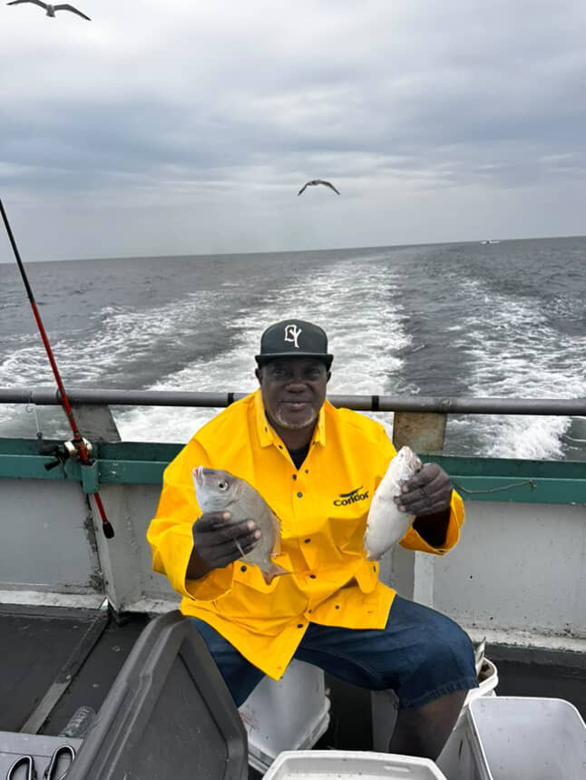 a man sitting in a boat on a body of water