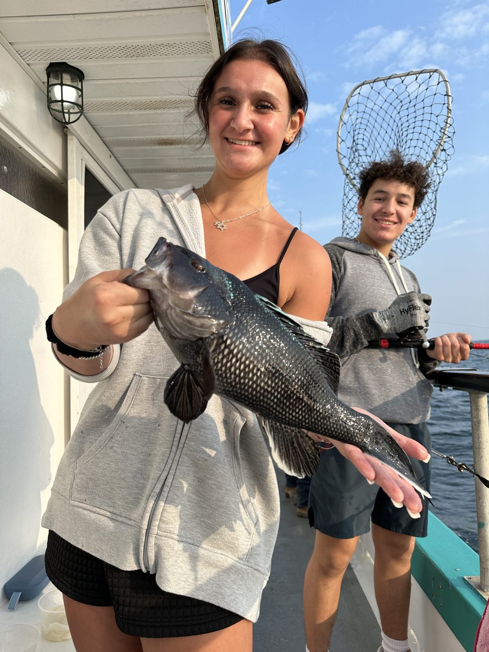a woman holding a fish
