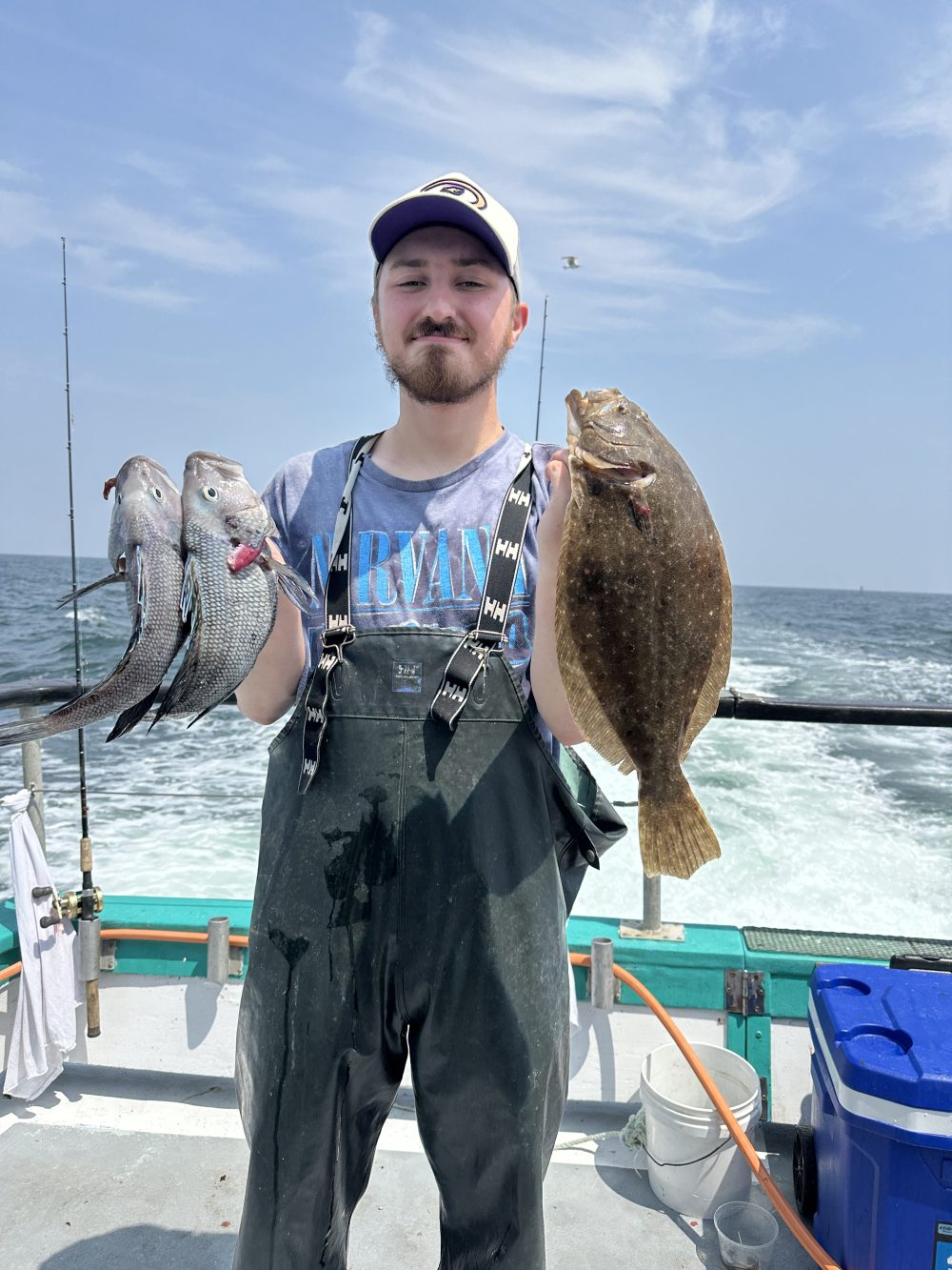 a person holding a fish on a boat in the water