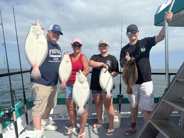 a group of people standing next to a person holding a fish