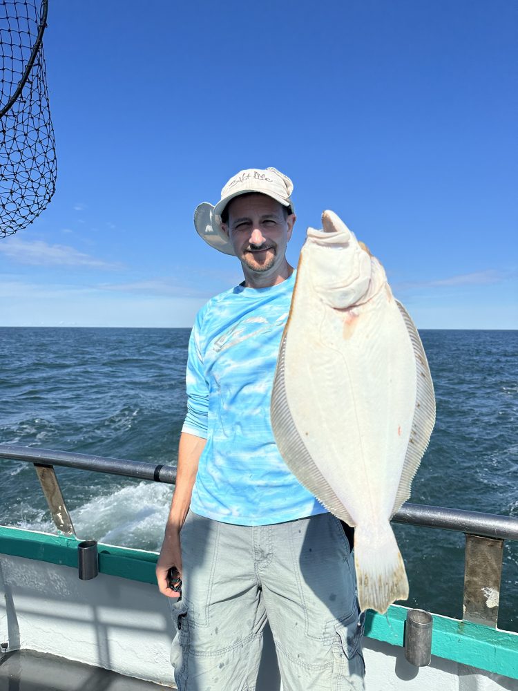 a person standing next to a body of water